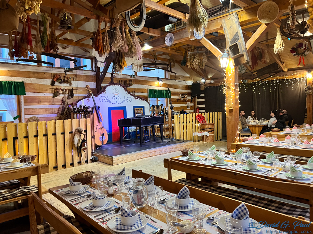 A wooden building with many wooden tables and benches