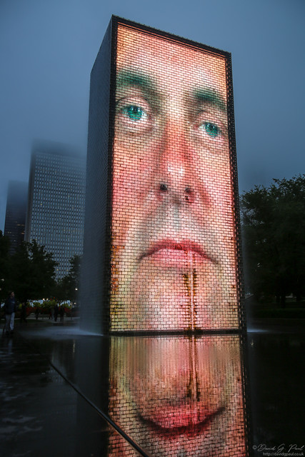 Waterfall lit by an image of a face behind it
