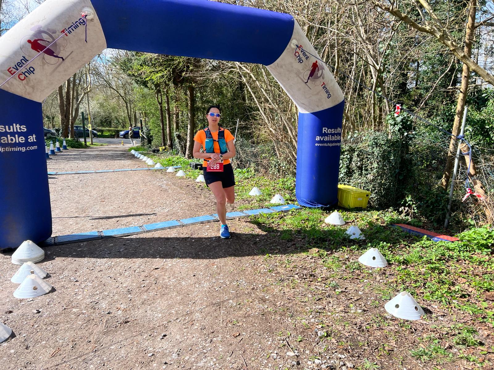 A female runner crossing a finish line